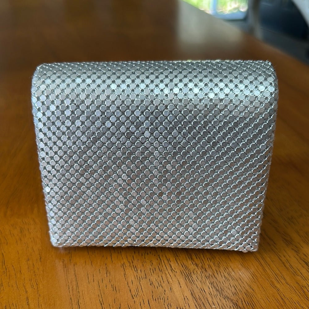 Silvertone small clutch purse. Magnetic closure. Chain strap if needed.